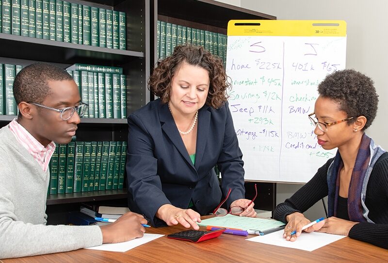 Divorce mediator with clients seated at a table